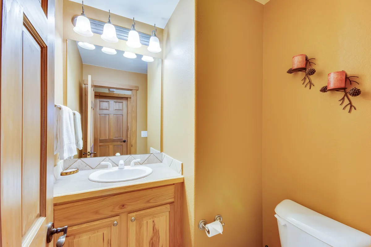 A modern laundry area with a vanity, mirror, and decorative wall accents. The space is bright, clean, and thoughtfully designed for daily routines and convenience.